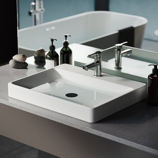 Large white rectangular vessel sink, modern design with single faucet hole.
