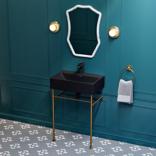 Matte black ceramic console sink with brushed gold legs and rectangular basin.
