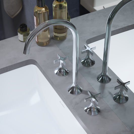 Widespread bathroom faucet in chrome with cross handles and high-arc spout on gray countertop.