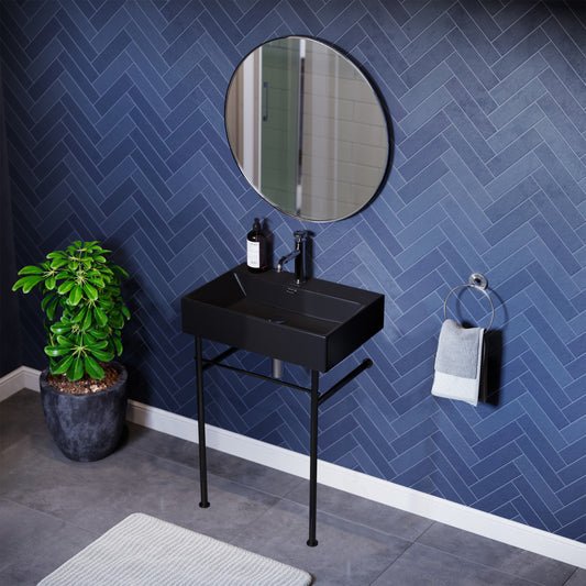 Matte black ceramic console sink with slim black legs and rectangular basin.