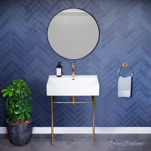 Small white ceramic console sink with gold metal legs and single hole faucet mount.