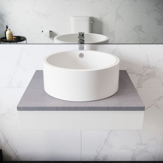 Round ceramic vessel sink in white, smooth finish, countertop installation.