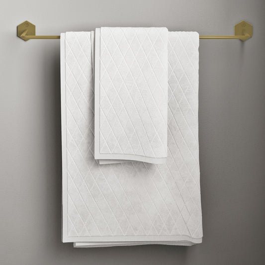 21-inch towel bar in brushed gold with geometric end brackets and white textured towels.