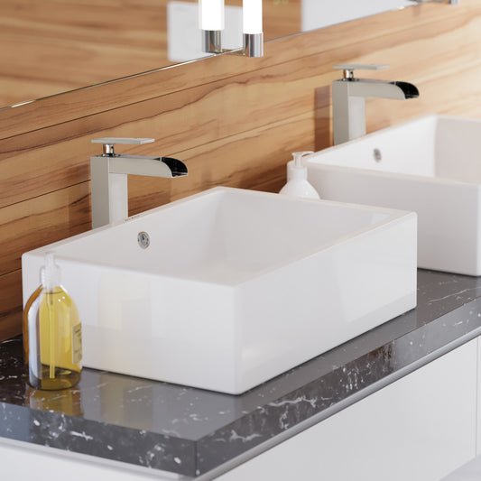 Rectangular white ceramic vessel sink on gray marble countertop with chrome single-handle faucet.